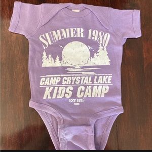 Three Halloween baby onesies